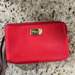 Michael Khors bright Orange wristlet with double compartment.